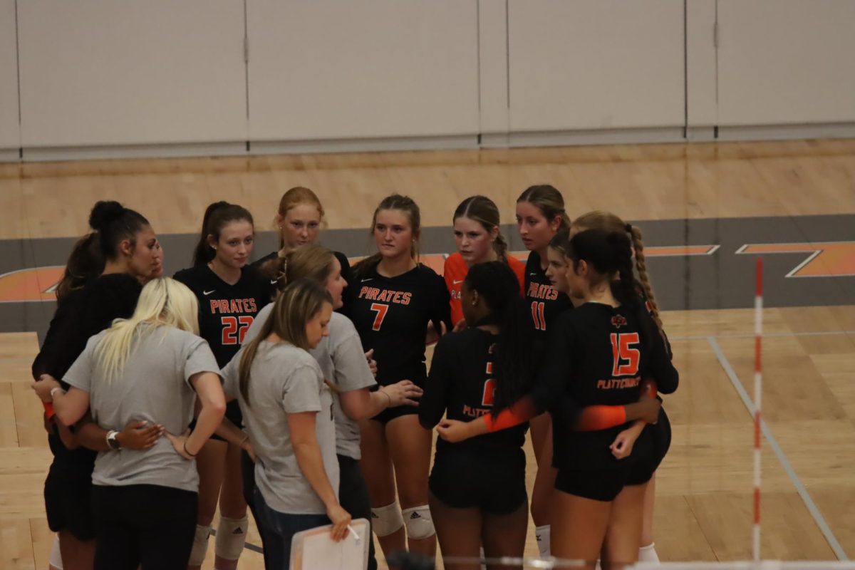 Volleyball team huddles during a game on Sept. 22