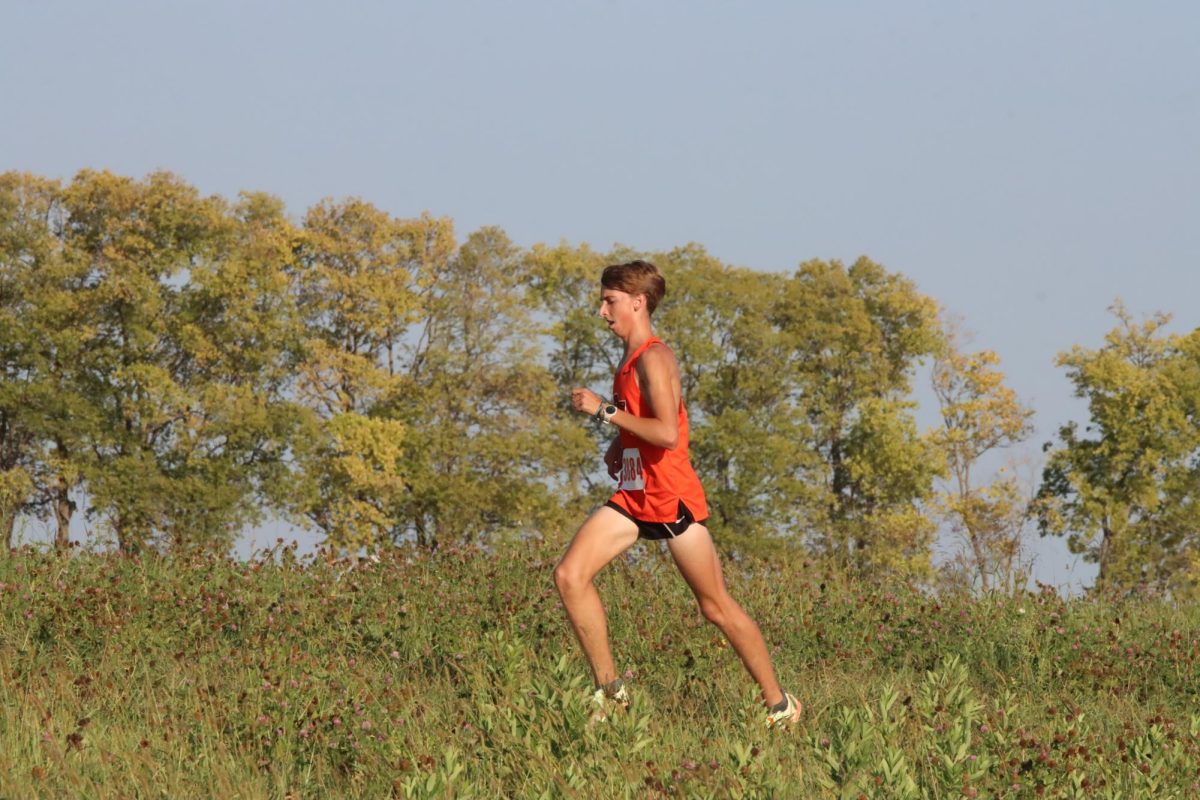 Senior Andrew Johnson gets through the final stretch of the race at Platte Ridge Park on Sept. 22.