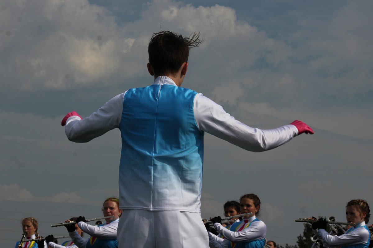 Drum Major Noah Smith conducts the band during warm-ups before the competition was cancelled on Sept. 23.