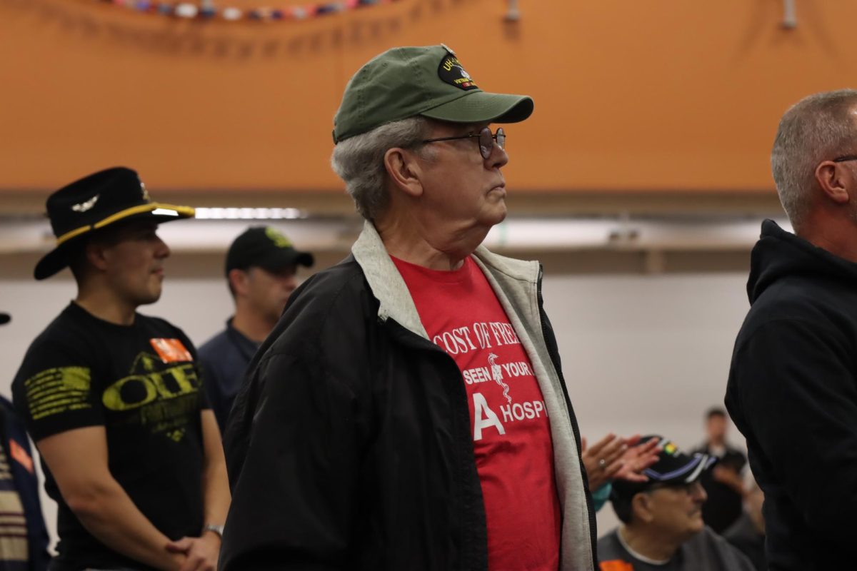 More veterans stand during their branch's song.