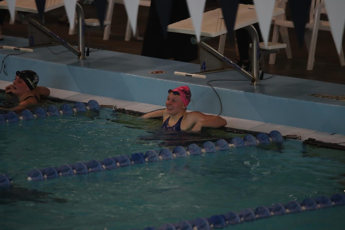 Hays checks a record breaking time during a meet in January 2023. 