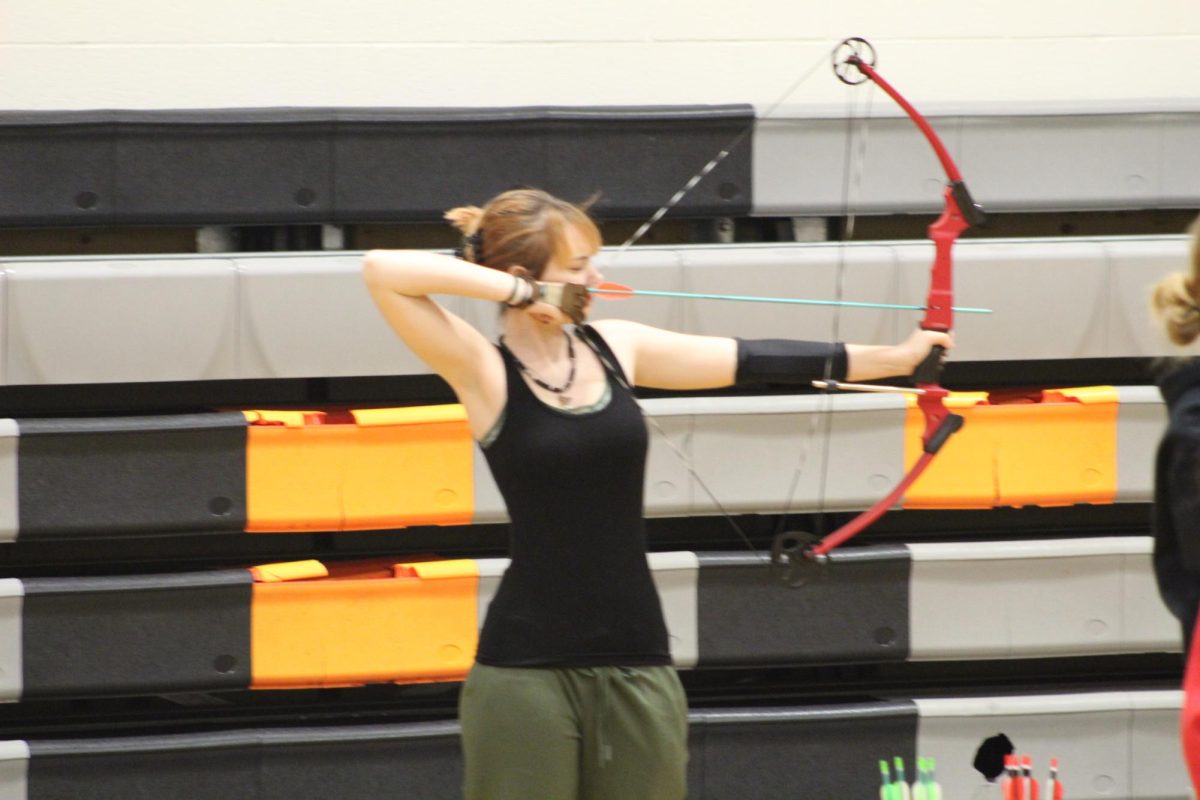 Freshman Zoey Worthley aims her bow at archery practice on Jan. 23