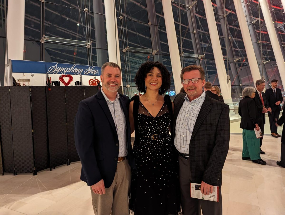 Washington (middle) poses with current director of bands, Matt Bonsignore (left) and retired director of bands, Jay Jones (right) on the evening of her KC Symphony composition debut at the Kauffman Center for Performing Arts. Photo contributed by Matt Bonsignore.