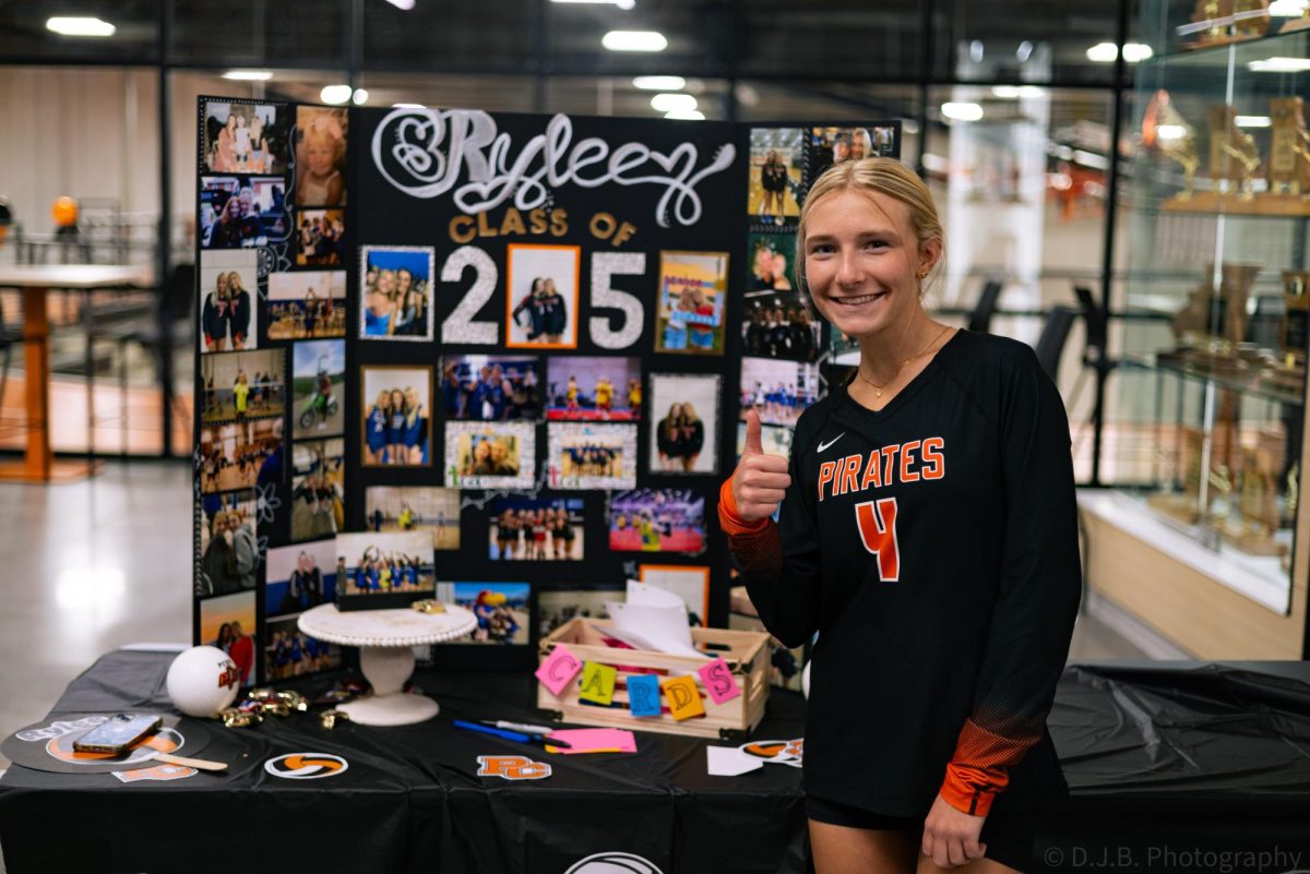 Senior Rylee Pickett poses next to her table during the Volleyball Senior Night on Oct. 10