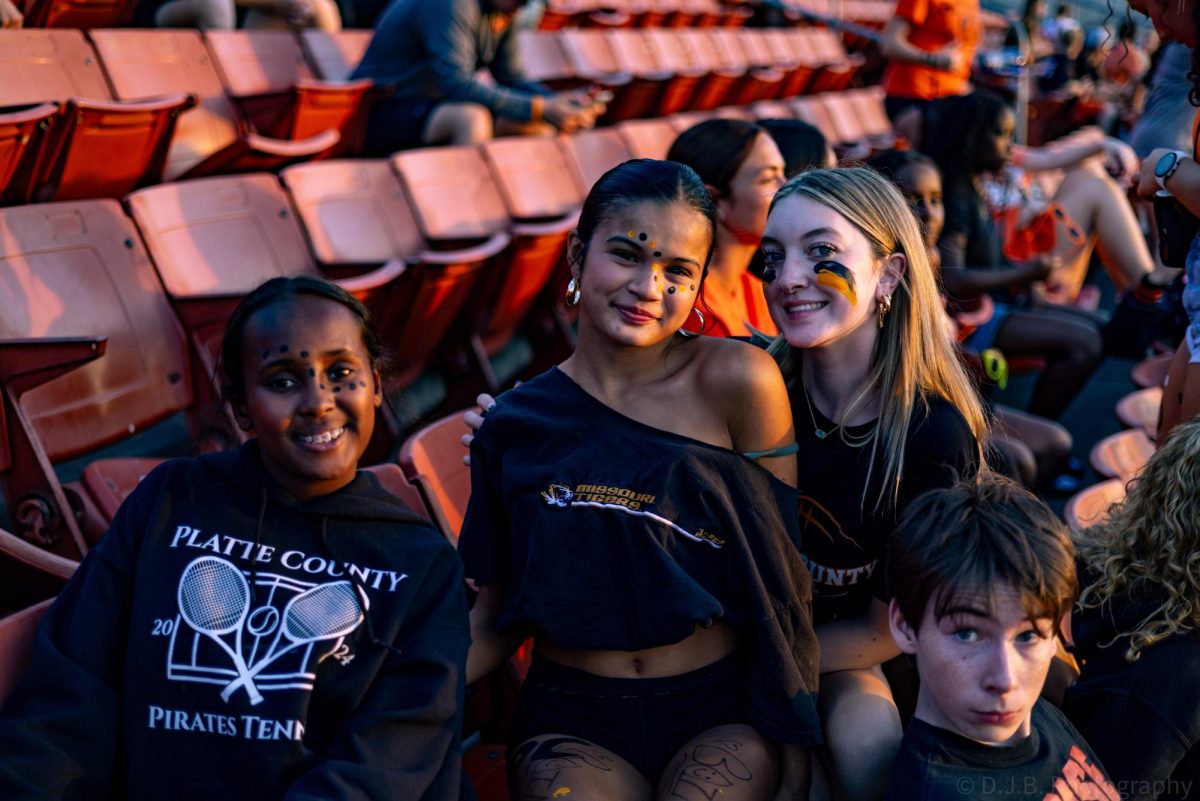 Sophomores Israa Elmi, Colin Bralley, Isha Shippert, and Vivienne Sayre pose for a photo in the stands 