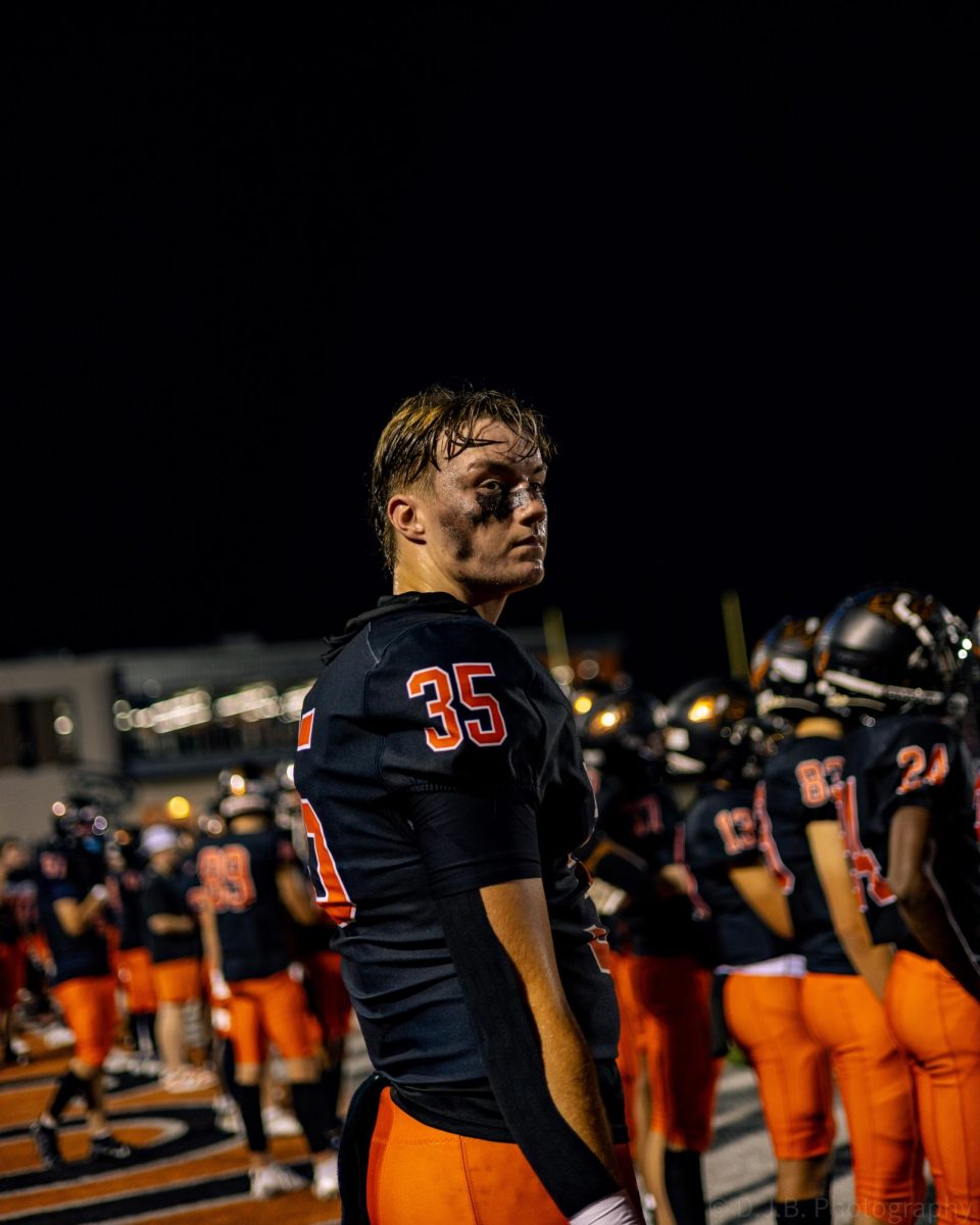 Junior Jack Utz watches his teammates play hard against the Truman Patriots 