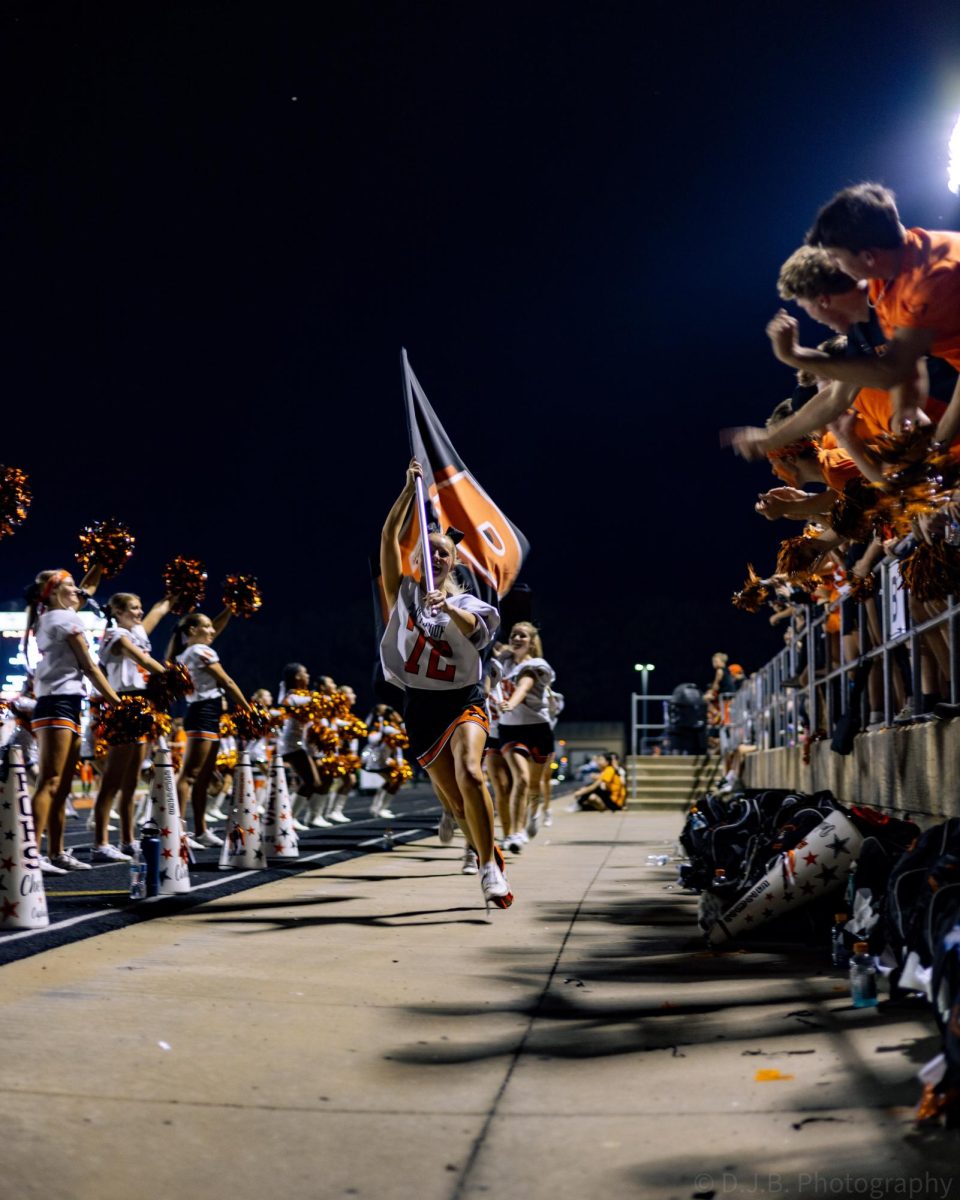 Platte County Cheerleaders running the pirate flags after a touchdown