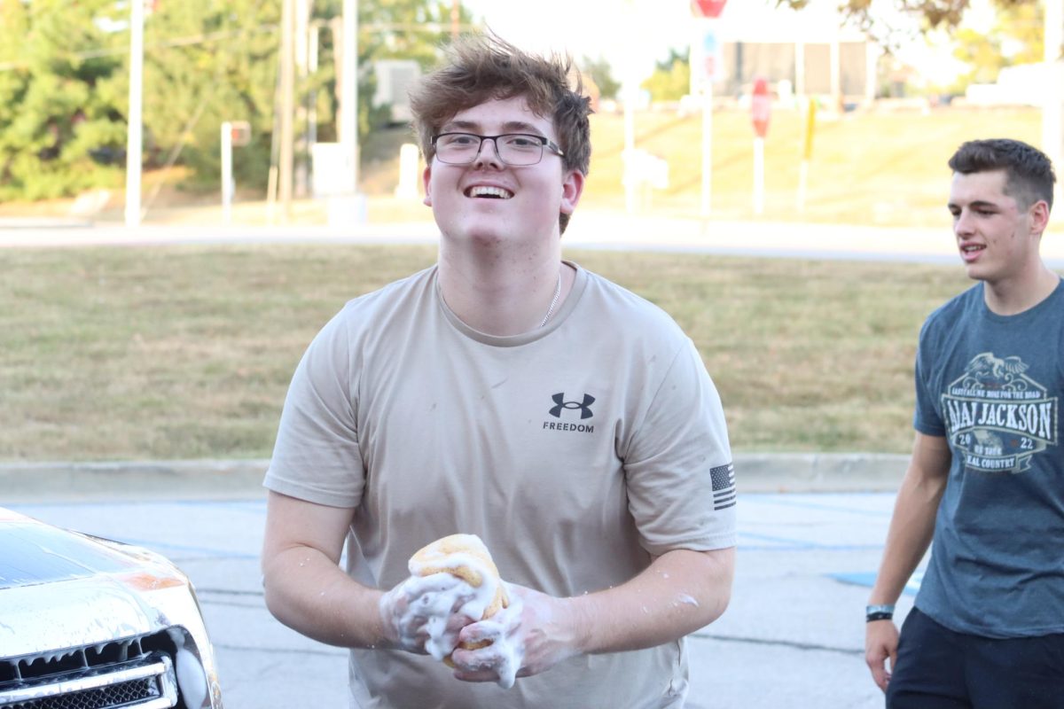 Senior Jacob Domann, president of TPUSA, at their carwash fundraiser on Sept. 17. 