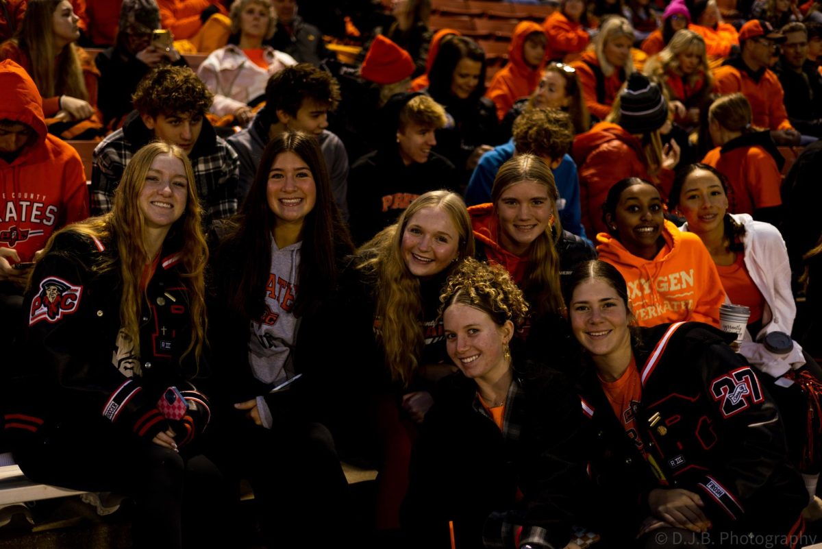 Students in the stands posing for a photo 