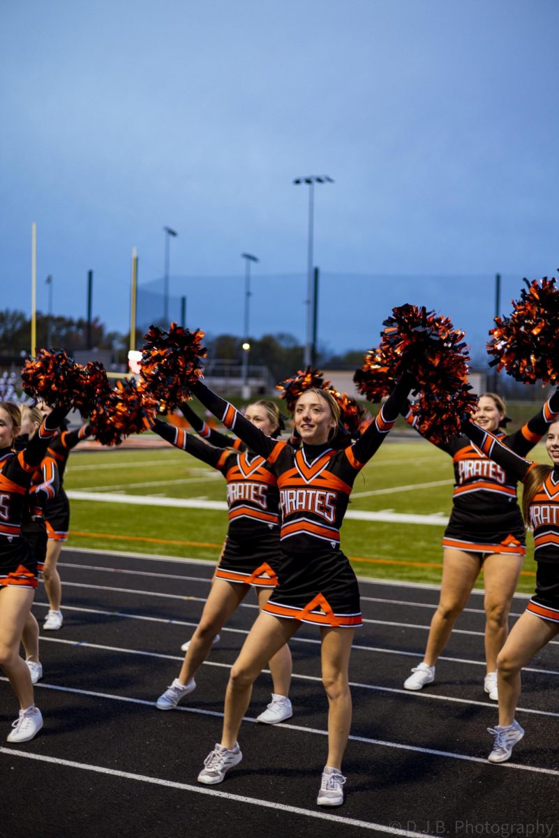 Junior Kinsley Acker cheers for the crowd early in the morning 