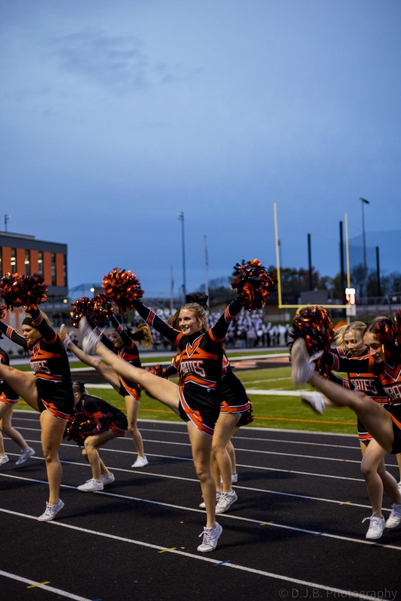 Junior Saylor Lembke cheers for the crowd early in the morning 